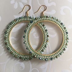 Extra Large Seed Bead Hoop Earringsp Hoop earrings made with metallic lime green and cream colored 11/0 beads with beautiful dual gold and green coated a/b Czech beads. The mixture of tones create a rich bright warm weather pallette. The french hook earwires and findings are 14kt gold plated. These very large very lightweight earrings measure approximately 3 inches (7.62cm) total. The beaded hoops are slightly over 2.5 inches (6.35cm). Great for anytime. You will absolutely love this color and s Green Beaded Hoop Earrings For Gift, Handmade Green Hoop Earrings For Party, Green Dangle Beaded Earrings With Gold Beads, Handmade Green Beaded Hoop Earrings, Green Beaded Dangle Hoop Earrings, Elegant Green Beaded Hoop Earrings, Green Hoop Beaded Earrings With Dangling Beads, Green Hoop Beaded Earrings, Green Hoop Earrings With Dangling Beads