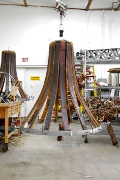 a large wooden structure sitting inside of a building next to other woodworking tools and equipment