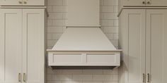 a white stove top oven sitting inside of a kitchen next to cupboards and drawers