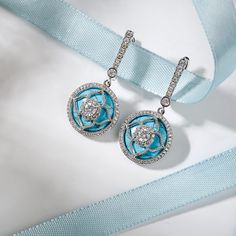 Sparkling and elegant, these drop earrings are perfect for any special occasion. Created in sterling silver, each drop features a flower set with a round cut stone in center wrapped in a halo frame of smaller round stones, which all finished in a turquoise. An awesome look of lucky, this exquisite and romantic choice is certain to become your favourite.Carat Weight: 5 ctStone Size: 12*12 mmStone Type: Jeulia® StoneNumber of Stones: 2 Stone Shape: RoundStone Color: TurquoiseCarat Weight: 17.818 c Elegant Turquoise Flower Earrings, Elegant Silver Flower Earrings With Gemstone, Elegant Turquoise Drop Flower Earrings, Elegant Turquoise Flower Drop Earrings, Turquoise Dangle Earrings, Turquoise Earrings Dangle, Sterling Silver Drop Earrings, Silver Drop Earrings, Online Earrings