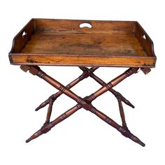 an old wooden tray with two crossed legs