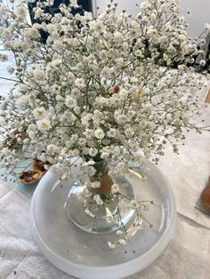 a vase filled with white flowers on top of a table