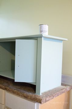 an empty cabinet sitting on top of a counter