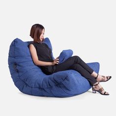 a woman sitting on a blue bean bag chair