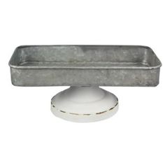 an old metal tray with a white base