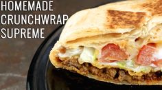 a close up of a burrito on a plate with the words homemade crunchwrap supreme