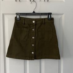 New Without Tags. Casual Cotton Mini Skirt With Buttons, Cotton Mini Skirt With Button Closure, Cotton Mini Skort With Button Closure, Trendy Cotton Skirt With Snap Buttons, Casual Mini Skort With Buttons, Trendy Button-up Cotton Skirt, Trendy Cotton Skirt With Button Closure, Green Mini Skirt With Button Closure, Casual Button-up Mini Skirt With Snap Buttons