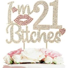 a 21st birthday cake topper with the number twenty one and two kisses on it