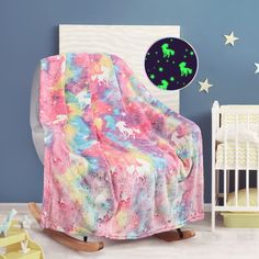 a child's room with a rocking chair, crib and stars