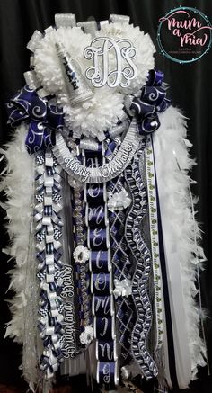 a dress made out of feathers with the letter m in white and blue on it