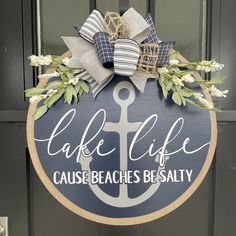 a sign that says lake life cause beach's beauty with an anchor on it