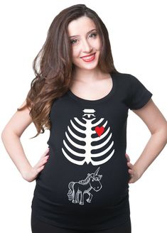 a pregnant woman wearing a skeleton t - shirt with a red rose on it's chest