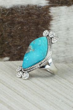 This turquoise and sterling silver ring was made by Navajo silversmith Selina Warner. The back is signed SW and stamped sterling.Size: 7Length: 1 1/2"Width: 3/4"Free shipping on all orders! We ship with USPS and always include tracking. All orders ship within a day of payment.Returns are accepted up to 30 days after you receive your order. Just send us a message. Our shop offers cash back or store credit. The item must be returned in new condition. Western Style Blue Turquoise Ring In Sterling Silver, Western Style Blue Turquoise Sterling Silver Ring, Southwestern Style Large Stone Turquoise Ring For Anniversary, Southwestern Style Large Turquoise Ring For Anniversary, Western Style Untreated Sterling Silver Rings, Western Sterling Silver Gemstone Ring, Western Sterling Silver Turquoise Ring, Western Style Sterling Silver Gemstone Ring, Western Style Turquoise Inlay Ring In Sterling Silver