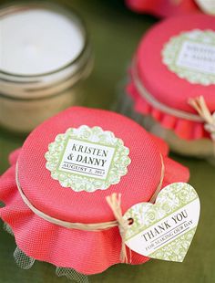 wedding favors are wrapped in red and green paper