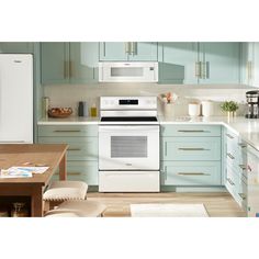 a white stove top oven sitting inside of a kitchen