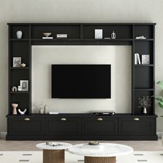 a living room with black shelves and a flat screen tv