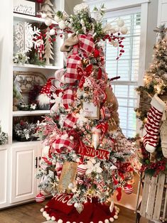 a christmas tree decorated with red and white ribbons