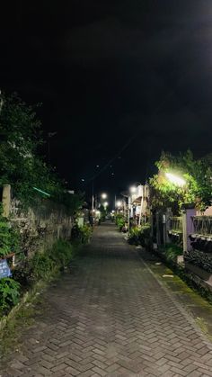 an empty street is lit up at night