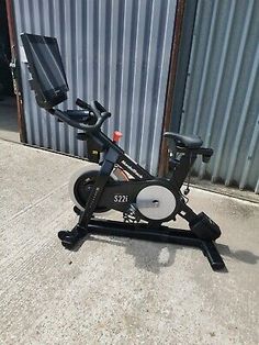 an exercise bike sitting on the ground in front of a building