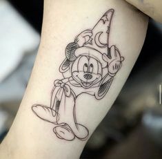 a person with a mickey mouse tattoo on their leg