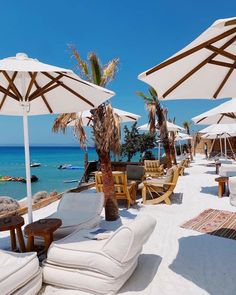 lounge chairs and umbrellas are on the beach