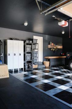 a black and white checkered floor in a garage with a truck parked next to it