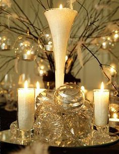 a table topped with lots of lit candles