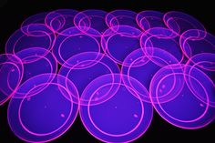 a bunch of purple circles sitting on top of a table