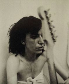 a black and white photo of a woman brushing her hair