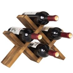 three bottles of wine are placed in a wooden holder that is shaped like an x