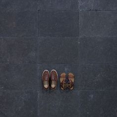 two pairs of shoes sitting on the ground next to each other