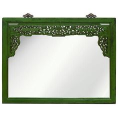 a green mirror sitting on top of a white wall