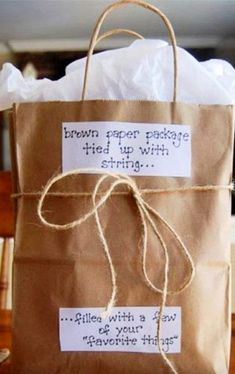 a brown paper package tied up with string on top of a bag that says, brown paper packages tied up with string