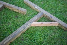 four pieces of wood laying in the grass