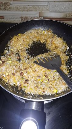 a frying pan filled with food on top of a stove