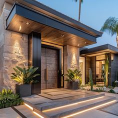 a modern house with steps leading up to the front door