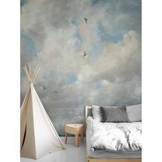 a bedroom scene with a teepee tent and birds flying in the sky above it