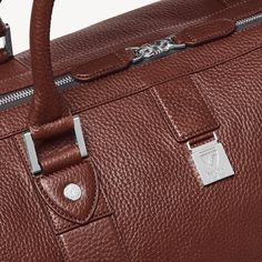 Classic Business Travel Bag In Textured Leather, Luxury Textured Leather Weekender Bag For Business, Luxury Textured Leather Business Weekender Bag, Leather Duffle Bag With Smooth Grain For Weekend Trips, Textured Leather Travel Bag For Business Trips, Leather Duffle Bag For Weekend Trips, Luxury Cognac Duffle Bag For Everyday, Luxury Everyday Cognac Duffle Bag, Luxury Textured Leather Travel Bag For Everyday