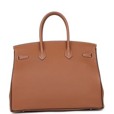 This Special Order Birkin Verso is in Gold togo leather with gold hardware and has contrast stitching, two straps with front toggle closure, clochette with lock and two keys and double rolled handles.The interior is lined with Macassar chevre and has one zip pocket with an Hermes engraved zipper pull and an open pocket on the opposite side.Collection: AOrigin: FranceCondition: Pre-owned; Excellent - This bag retains its shape. The exterior is clean but the bottom corners and the handles show minor signs of wear. There's no plastic on the hardware and some scratching on the feet and left pull strap plate. The interior leather has some signs of wear.Accompanied by: Hermes box, Hermes dustbag, clochette, lock, two keys, clochette dustbag, felt, carebookMeasurements: 13.75" width x 11" height Brown Togo Leather Bag With Gold-tone Hardware, Designer Brown Togo Leather Bags, Brown Togo Leather Business Bags, Brown Togo Leather Travel Bag, Timeless Brown Togo Leather Bag, Formal Brown Togo Leather Bag, Hermes Special Order, Hermes Birkin 35, Hermes Birkin 25