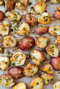 roasted potatoes with herbs and seasoning on a baking sheet