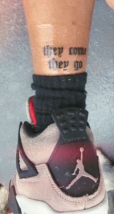 a person with a tattoo on their leg wearing sneakers and socks that say, they come very no