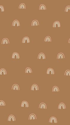 a brown background with white rainbows on it