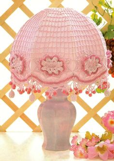 a pink lamp is sitting on a table