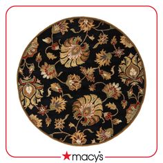 a black rug with gold, red and green flowers on the center is shown in front of a white background