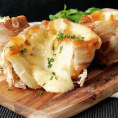 some food is sitting on a wooden cutting board