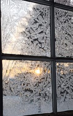 frosted window panes with the sun shining through them on a cold winter day