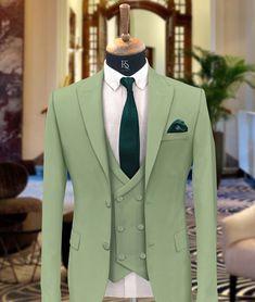 "Men Suits, Suits For men light green three piece Wedding Suit, Formal Fashion Slim Fit Tuxedo Suit  COMPULSARY  PLEASE MEASURE YOUR CHEST AREA, CIRCUMFRENECE AROUND THE BROADEST PART OF CHEST AND WAIST AREA WHERE YOU NORMALLY WEAR YOUR TROUSER OR 4 FINGER BELOW THE BELLY BUTTON, AND PICK YOUR SIZE ACCORDINGLY  PLEASE PROVIDE YOUR HEIGHT AND WEIGHT IN THE PERSONALISATION BOX , WHILE PLACING THE ORDER PLEASE CHECK THE SIZE CHART BEFORE PLACING THE ORDER IN SIZE CHART , \"WAIST\" REFERS TO THE AREA WHERE YOU NORMALLY WEAR YOUR TROUSERS. This Elegant Fashion 3 piece suit With Matching Vest And Trousers for Men Is Perfect For every one Who Loves formal Suits. This Designer Suit will be Handcrafted Specially For You only after You Place an Order. Fabric:- Terry Rayon Premium Includes:- Coat Ves Light Green Tuxedo For Men, Till Green Color, Classic Green Double Breasted Suit For Groom, Green Double Breasted Notch Lapel Suit For Groom, Fitted Green Three-piece Suit For Groom, Green Fitted Three-piece Suit For Groom, Fitted Green Three-piece Suit For Grooms, Fitted Green Tuxedo For Wedding, Classic Green Blazer For Groom