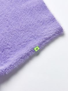 a close up of a purple towel on a white surface