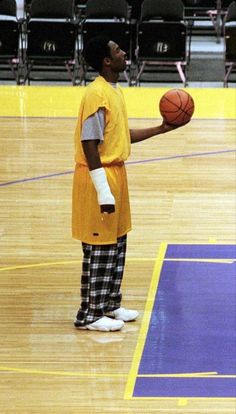 a man in an orange shirt holding a basketball