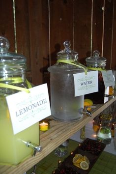 lemonade and water are on display in glass jars with tags attached to them that read lemonade